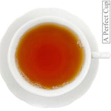White cup and saucer with a steaming cup of tea on a white background, featuring 'A Perfect Cup' branding.