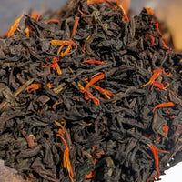 black loose leaf tea with orange flower petals