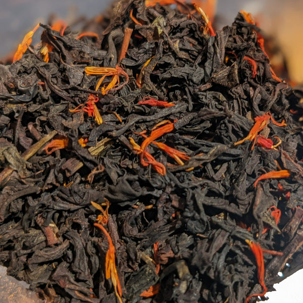 black loose leaf tea with orange flower petals